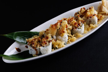 Tempura shrimp maki roll with cucumber Japanese food isolate in black background