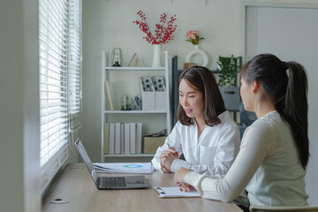 Asian Bussiness woman using laptop consult business finance strategy.