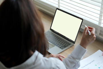 Blank screen laptop computer. Business woman looking empty laptop screen mock up.