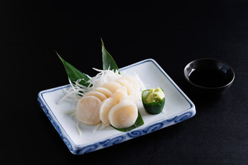 japanese scallop sashimi isolated in black background