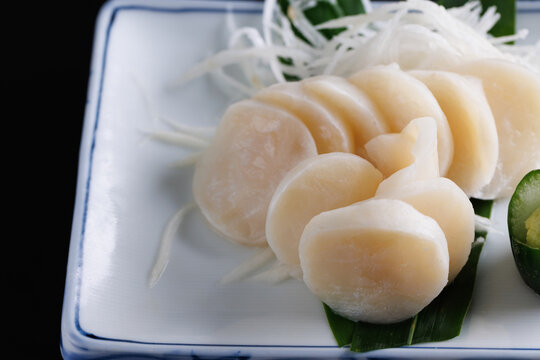 japanese scallop sashimi isolated in black background