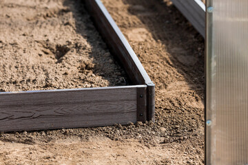 A new greenhouse made of polyethylene and polycarbonate with new beds made of Wood-polymer...