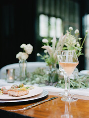 Elegant dining experience featuring gourmet meal and refreshing drink in a beautifully arranged table setting