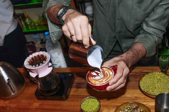 Barista crafting a specialty coffee with latte art skills
