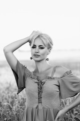 Portrait of a beautiful young blonde girl in nature. Black and white photo.