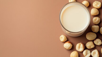 top-down view of scene is product photography setup with studio lighting glass of creamy macadamia milk surrounded