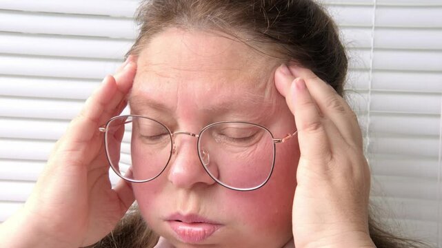 50-year-old woman experiencing hot flashes due to menopause and high blood pressure, high blood pressure. Health concerns