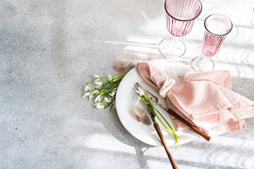 Elegant table setting with spring snowdrops from above