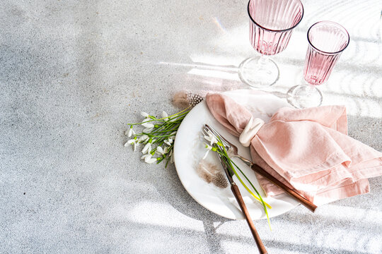 Elegant table setting with spring snowdrops from above