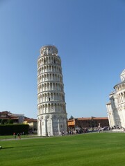 Leaning Tower of Pisa with clear blue sky.