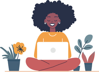 A cheerful African American woman enjoying remote work on her laptop in a comfortable home setting.