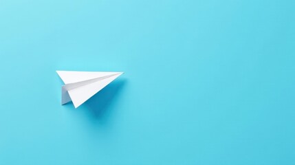 A Simple White Paper Airplane Soaring Across a Vibrant Blue Background, Symbolizing Dreams of Flight and Journeys to New Horizons
