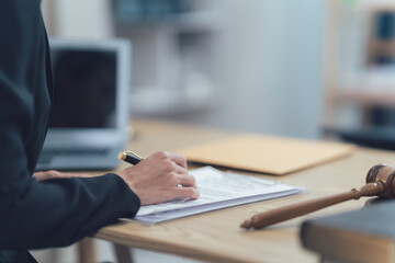 Legal Professional Signing Documents: A close-up of a legal professional signing a document,  with...