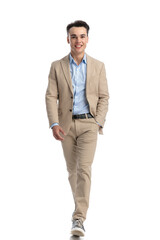 happy smart casual man walking while holding pocket