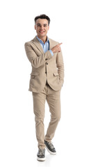 relaxed student walking forward and pointing finger to side