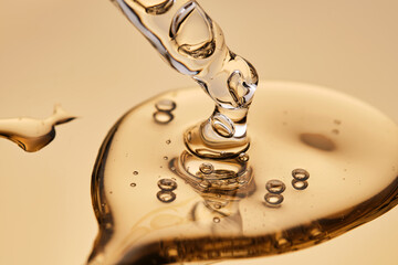 A pipette with a beautiful drop of gel-textured facial serum.