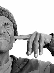 man suffering from deafness and hearing loss on grey background with people stock photo