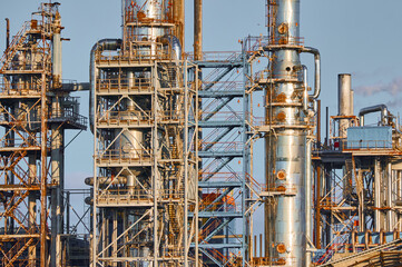 Industrial distillation column and chemical plant structure showcasing advanced manufacturing processes in operation under clear skies