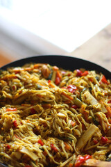 Bowl of stir fry vegetables and noodles, served on the table. Selective focus.