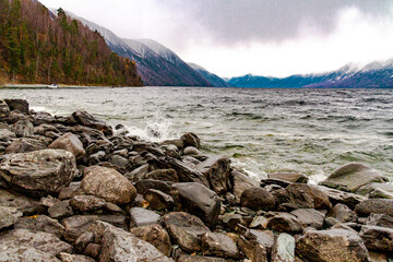 Stone on the Teletskoye lake shore in rainy autumn, Altai, Siberia, Russia, October