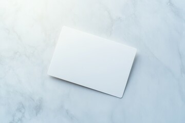 modern blank credit card placed on smooth metallic background with subtle reflections illuminated by bright studio