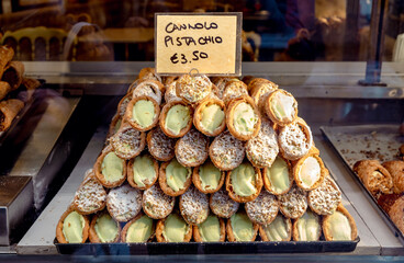 Traditional Italian cannoli pastry with pistachio filling for sale on the street in Italy