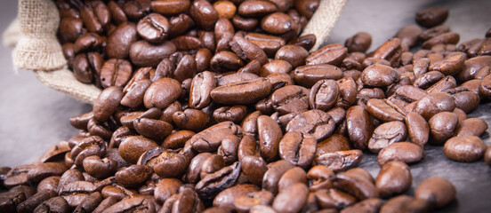 Dark roasted fragrant coffee beans in jute bag