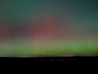 Breathtaking Aurora Borealis with Vibrant Green and Red Lights Over the Horizon, photo taken in Germany