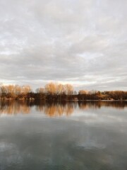 Lake view in winter, with sunset lighting up the trees