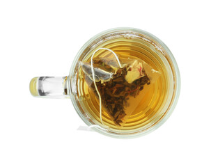 Tea bag in glass cup with hot drink isolated on white, top view