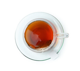 Tea bag in glass cup with hot drink isolated on white, top view