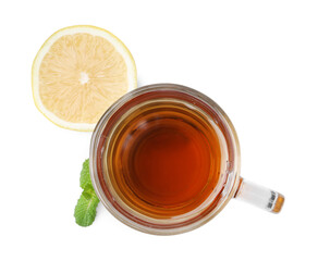 Tasty mint tea in cup, lemon and fresh leaves isolated on white, top view
