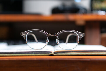 Cozy Workspace with Eyeglasses and Candle