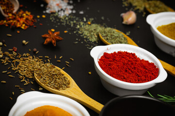 Variety of spices and herbs on kitchen table. Side view