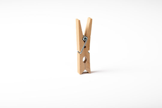 Wooden clothes peg isolated on white background
