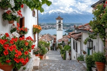 A cobblestone street in a historic town, its lengthy path lined with colorful buildings and flower pots