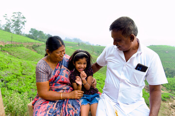 Grandparents and Granddaughter Enjoying Scenic Countryside View