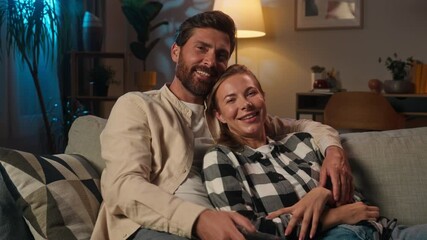 Love couple Caucasian family man woman husband wife relax together on couch sofa at evening home romantic weekend affectionate girl guy watching television switch TV channel movie bonding hug talking - Powered by Adobe