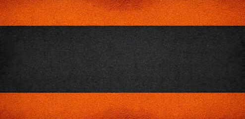 A bold, horizontal stripe of black is flanked by vibrant orange bands, creating a striking contrast. The rough, granular surface adds an element of tactile depth to the composition.AI