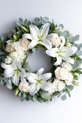 A round bouquet of lilies, roses, and greenery used as a decorative wreath for events or weddings.