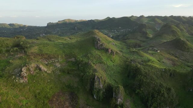 Drone overview of Ome&ntilde;a Peak rugged terrain, surrounded by verdant forests and clear skies