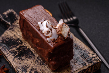 Piece of sweet chocolate bounty cake with coconut flakes and sponge