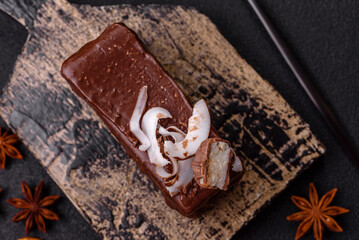 Piece of sweet chocolate bounty cake with coconut flakes and sponge