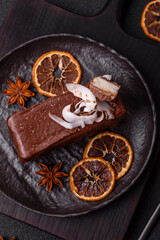 Piece of sweet chocolate bounty cake with coconut flakes and sponge
