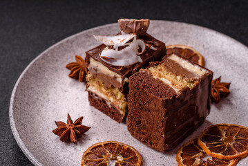 Piece of sweet chocolate bounty cake with coconut flakes and sponge