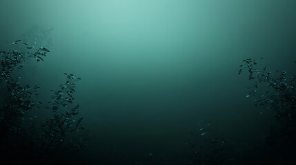 Fototapeta premium Silhouetted plants against a dark teal foggy background