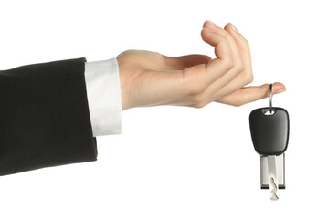 Woman with car key and keychain on white background, closeup