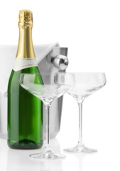 Bottle of champagne, empty glasses and ice bucket isolated on white