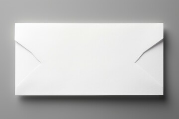 Studio shot of a closed white envelope lying on a gray background, representing communication and correspondence