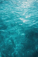 Fototapeta premium A view of water with sun glistening on the surface.